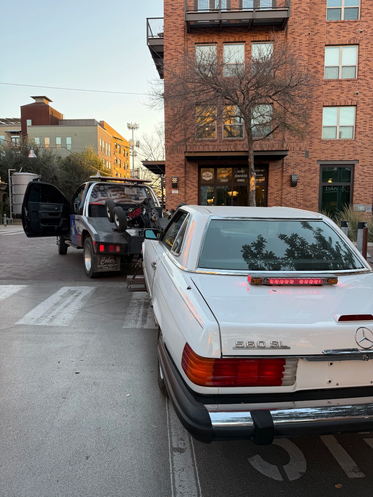 white Car being towed by the tow truck of texas patriot towing